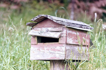 Rural mailbox on a old wooden post out on a country road