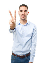 Fototapeta premium Young man with a gesture of victory