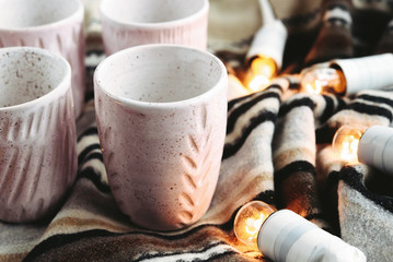 stylish creative ceramics cups and christmas garland lights, hol