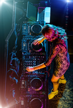 Beautiful DJ girl mixing electronic music