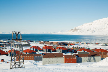 LONGYEARBYEN, SPITSBERGEN, NORWAY - 03 APRIL, 2015: Small town Longyearbyen among snow-capped mountains of the Norwegian archipelago of Svalbard.