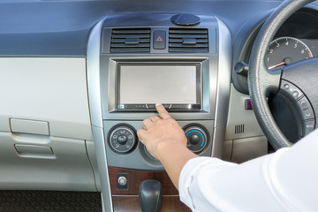 female hand pushing the power button to turn on the car radio