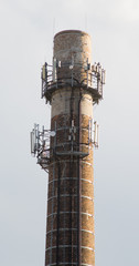 Chimney brick smoke stack with mobile phone antenna