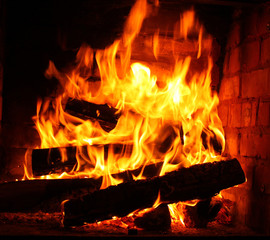 Obraz premium Fire in burning fireplace in winter close-up