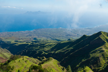Steep green valley viewpoint leading to blue ocean coast of cape verde island