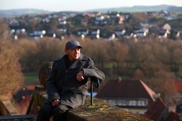 Fototapeta premium Elderly man resting in the city