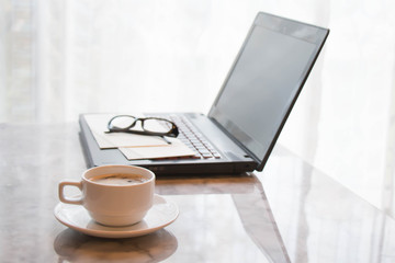 Coffee cup and laptop  for business office table concept working