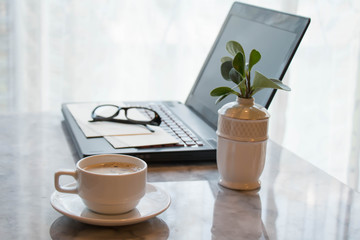 Coffee cup and laptop  for business office table concept working