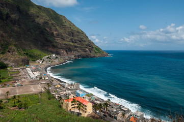 Small town with soccer football pitch at black rock stone beach coast on cape verde island