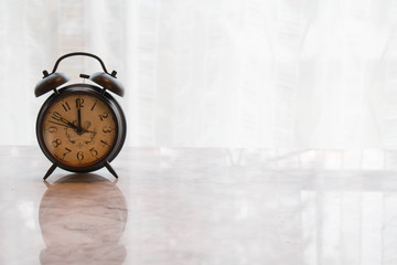vintage alarm clock on marble table