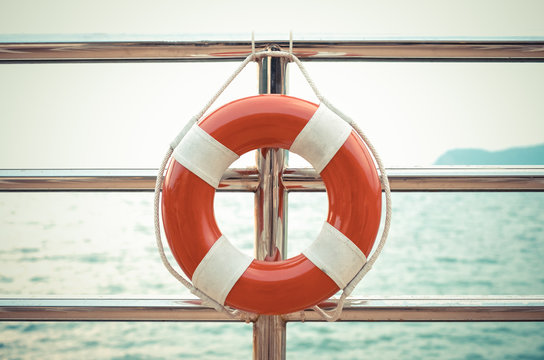 Vintage style photo of life preserver attached to the cruise shi