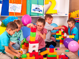 Group children game blocks on floor .