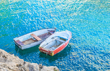 Two old rowing boats on the ocean