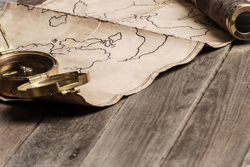 An old brass compass on map background
