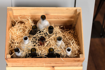 empty wine bottles in a wooden box
