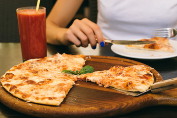 Eaten pizza and glass of tomato juice on the table in the pizzer