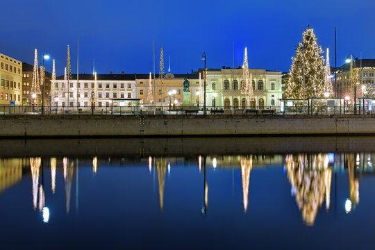 Gustaf Adolf's square in Gothenburg in the evening, decorated for Christmas and reflecting in the water of the main harbour canal, Sweden