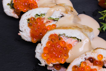 Stuffed chicken fillet with red caviar, closeup