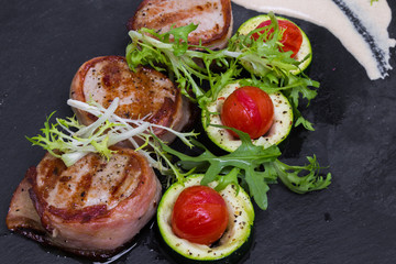 Grilled pork medallions with bacon