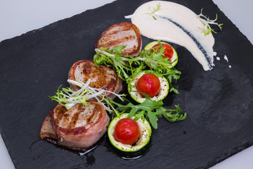 Grilled pork medallions with bacon