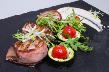 Grilled pork medallions with bacon