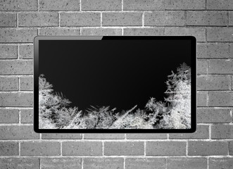 Blank screen LCD tv with frost screen hanging on a wall - obrazy, fototapety, plakaty