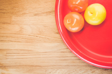 ripe plums red dish  - fresh fruits backgrounds