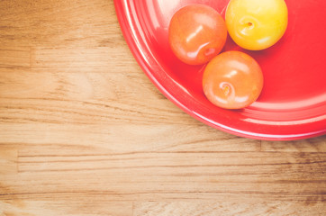 ripe plums red dish  - fresh fruits backgrounds