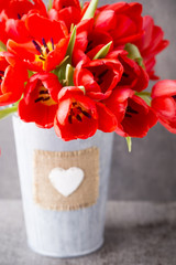 Red tulips on a wooden background.