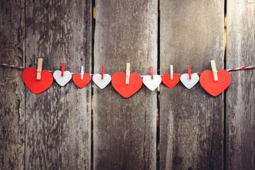 Red paper heart hanging on the clothesline