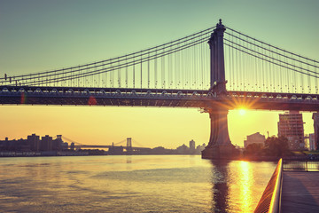 Colorful sunset behind historic Brooklyn Bridge