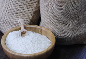 White rice in bowl against of two textile bags