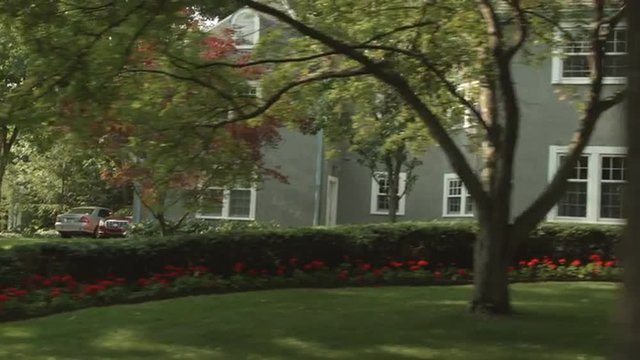 Driving plate: left three-quarters (passenger side) view, upper middle class 1930s and 40s-era homes in an affluent Mid West US neighborhood.  24mm lens, stabilized clip, moderate speed