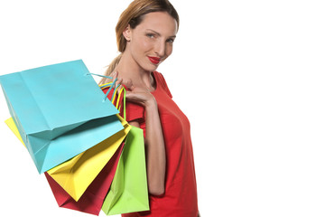 Woman carrying colorful shopping bags on shoulder