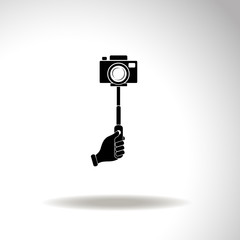 Monopod camera with hand vector icon.