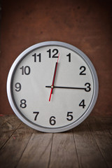 white clock on a table with old steel background,vintage style