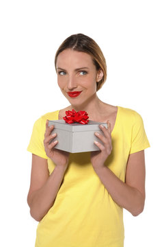 Beautiful young woman holding a gift box