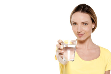 Portrait of a happy woman holding a glass of fresh water