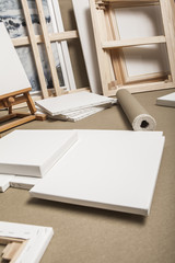 Empty white painter canvases and canvas roll and easel - painter