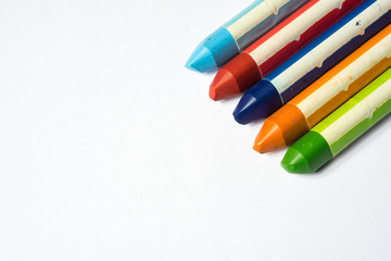 close up of used crayoms isolated on white
