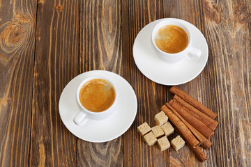 Two cup of hot esspresso, cinnamon and sugar cane