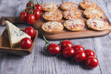 Mini pizzas on a wooden table