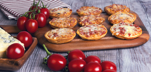 Mini pizzas on a wooden table