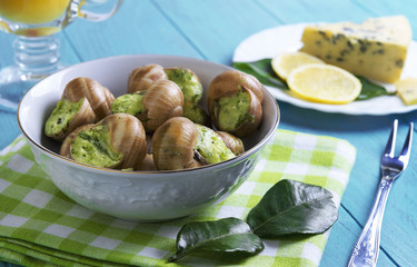 Burgundy snail on a wooden tray