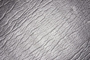 Reflecting light, crumpled wavy material texture.