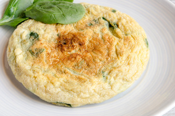 Omelet with spinach on plate