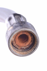 Old flexible metal hose pipe isolated on with white background