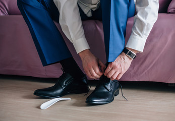 Businessman or groom wears shoes