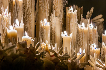 Some burning candles of wax that are melted and other candles of wax you extinguish in the Holy Week of Seville
