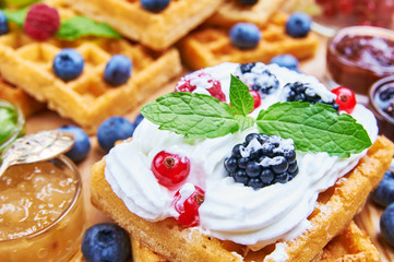 Homemade waffle with fruits and whipped cream